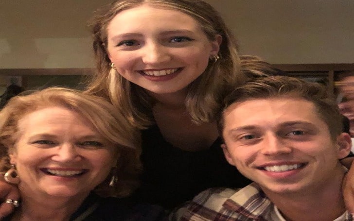 Geraldine Leer smiling with her son and daughter.